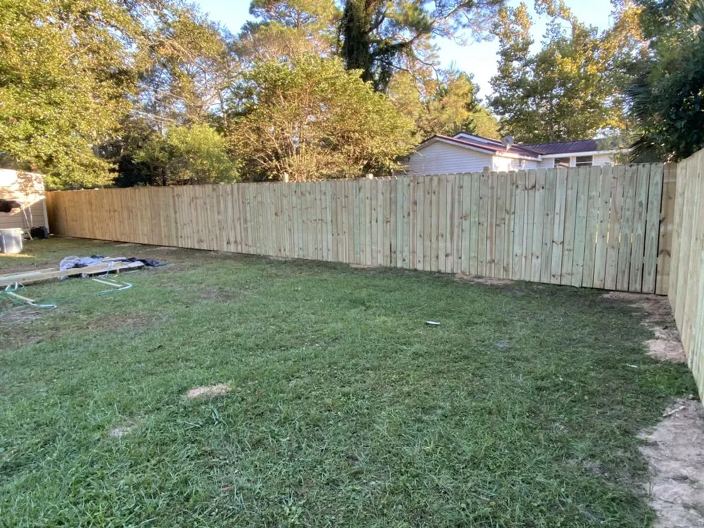 Professional wood fence service for homes in Milton, FL by Close Enough Construction
